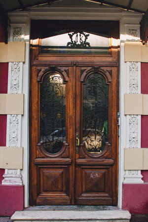 Old wooden weathered door in ancient town architecture.の写真素材
