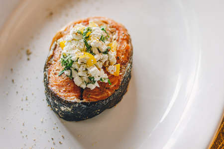 Catering table set service at restaurant before party. Fillet of salmon on a plate.の写真素材