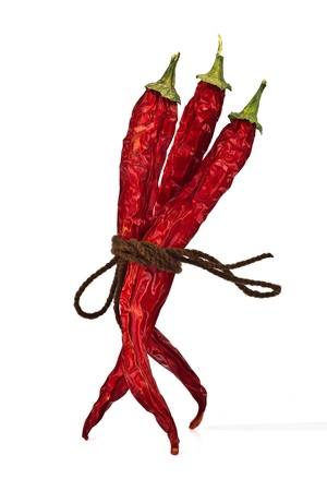 Red chili peppers tied by rope isolated on the white backgroundの写真素材