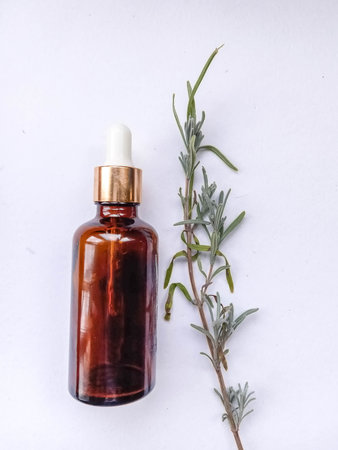 Flower and grapeseed oil. A bottle of oil and plants on a white background.
