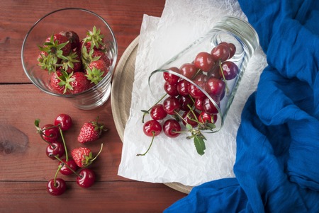 ripe cherry and strawberry in a glassの写真素材