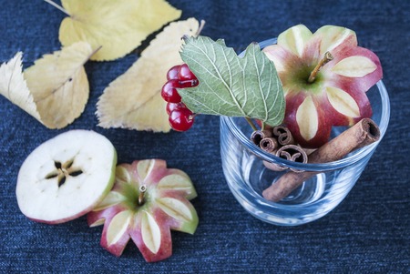 apple with cinnamon sticks on a blue backgroundの写真素材