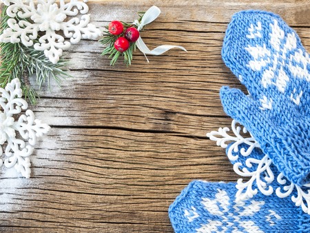mittens and Christmas decorations on a wooden backgroundの写真素材