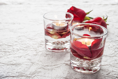 St. Valentines Day. A candle and red roses in glasses.の写真素材
