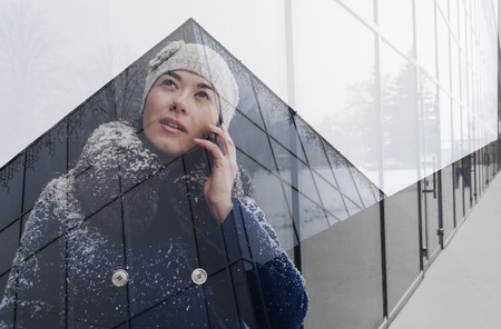young woman calling by phone . Double exposure.の写真素材
