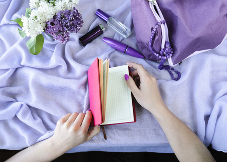 Woman holding a notebook, view from above, spring moodの写真素材