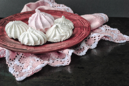 Meringue in a plate on a dark backgroundの写真素材