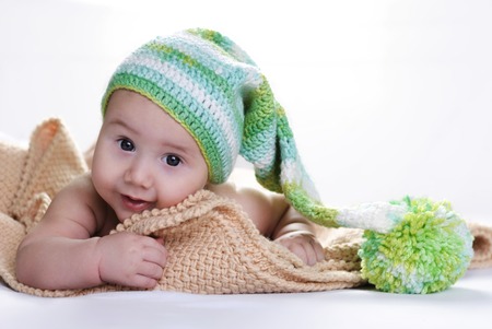 baby in a knitted cap on a light backgroundの写真素材