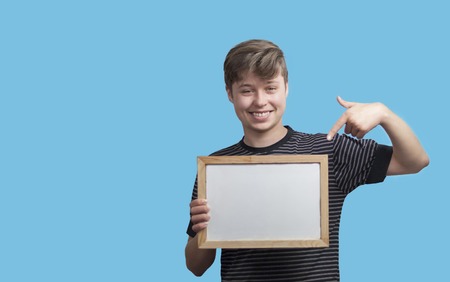 Boy teenager holding with the blackboard, copy spaceの写真素材