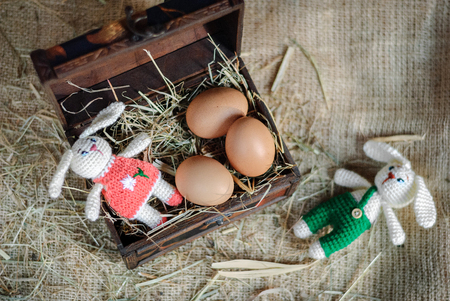 Easter decor eggs, knitted bunny on gray background. Handmadeの写真素材