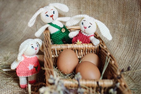 Easter decor eggs, knitted bunny on gray background. Handmadeの写真素材