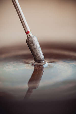 Close-up of a tool in a drop of water.の写真素材