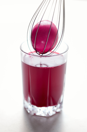 Easter eggs painting. Egg painted in crimson. Vertical imageの写真素材