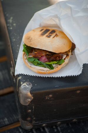 Street food. Burger with spinach, strawberries and duck