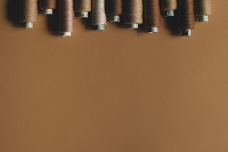 A brown of threads on coral paper background, with copy space. Brown colorの写真素材