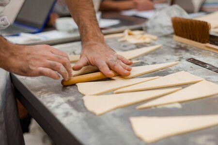 The process of making croissants in a bakery. Selective focus