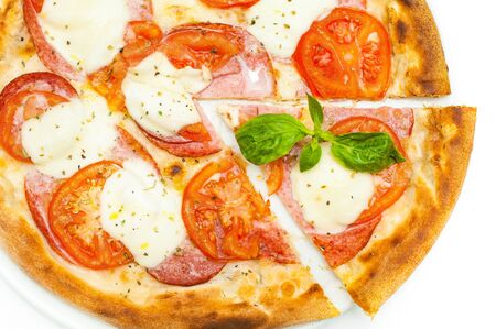 Pizza with tomatoes, ham and mozzarella on a white background. Piece of pizza. Top viewの写真素材