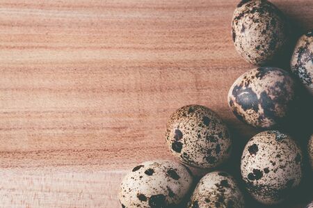 Quail eggs on a wooden background. Horizontal tinted photographyの写真素材