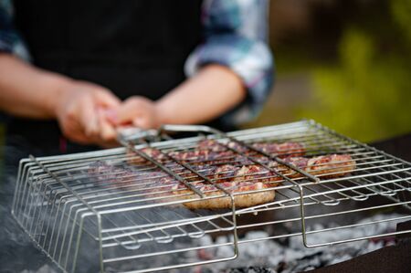 Hot sausages on the grill.. Ho sausage grilling outdoors on a barbecue grill.の写真素材