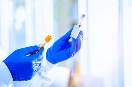 Medical workers, laboratory assistants work with test tubes for the analysis of biomaterials in...