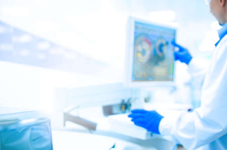 Laboratory assistant in rubber gloves working with a modern immunochemistry analyzer. concept of medical, chemicals or scientific laboratory research and Innovation in the laboratory.の写真素材