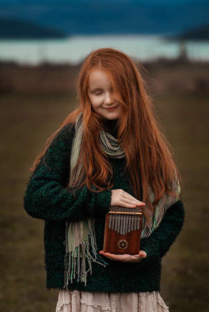 The girl plays the kalimba. Percussion instrument. Soft focusの写真素材