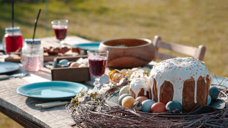 Served festive wooden table with dishes and food in the gardenの写真素材