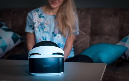 Helmet of virtual reality. Girl wants to get experience using glasses of a VR headset. Amazing emotions, cool rest, reboot.の写真素材