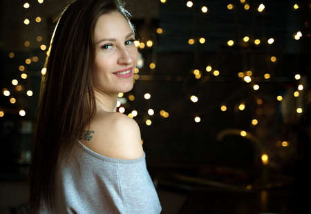 Beautiful girl in a cozy sweater in anticipation of christmas, happy carefree life.の写真素材