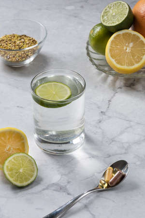 Morning with a glass of water and vitamins. Metabolism boosters. Healthy lifestyle concept.の写真素材