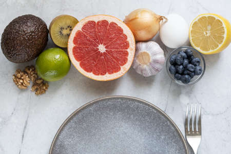 Set of fruits, vegetables, berries and nuts. Metabolism boosting food. Top view.の写真素材