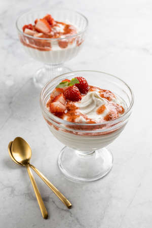 Healthy breakfast with cottage cheese, cream and strawberry and basil sauce. Homemade dessert, selective focus.の写真素材