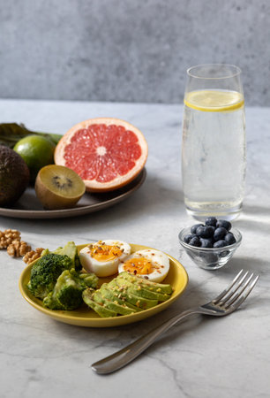Healthy breakfast to improve metabolism with boiled eggs, vegetables, fruits, seeds and nuts.の写真素材