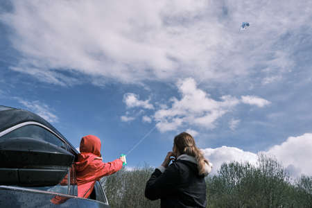 Mother and daughter flying a kite. Family outdoor activity.の写真素材
