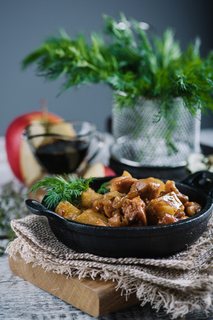 Roasted chicken with apples and dill in black iron panの写真素材