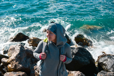 Young woman traveller with backpack at Black sea