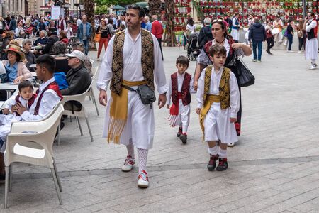 A family in traditional holiday peasant (huertano) clothes walking in the square during the spring festival of Bando de la Huerta in Murcia, Spain, on April 23, 2019.のeditorial素材