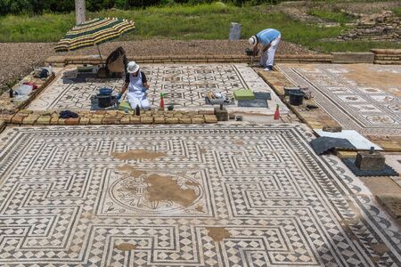 Santiponce (Sevilla), Spain, May 4, 2017. Restorers restore the mosaic on the ruins of the ancient roman city of Italica.のeditorial素材