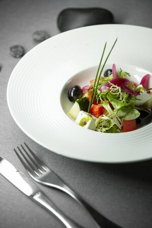 salad with feta cucumber, tomato, olives, greek on a gray backgroundのeditorial素材