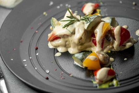 Fish with mashed potatoes and sauce on a gray background with stonesのeditorial素材