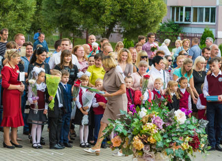 Minsk, Belarus - September 1, 2018 The teacher gives children gift books at a solemn meeting devoted to the day of knowledgeのeditorial素材