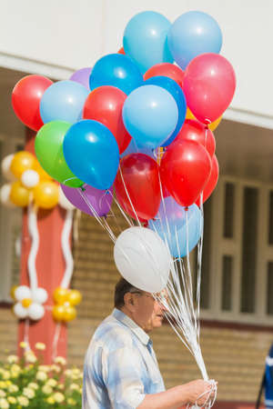 Minsk, Belarus - September 1, 2018 Father with a bouquet of balloons on the holiday devoted to the day of knowledgeのeditorial素材