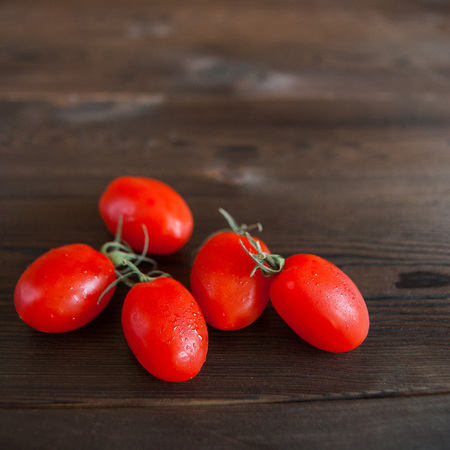 cherry tomatoes on wooden backgroundの写真素材