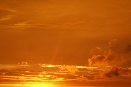 evening sky and clouds of rich orange colorの写真素材