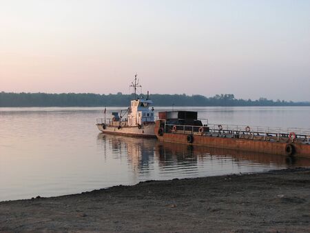 Evening view of the river on the sandy Bank of which stands the Old ferryの写真素材