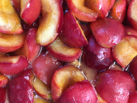 Homemade red Apple jam. Apple slices with yellow juicy flesh and red skin are cooked in sugar syrup.の写真素材