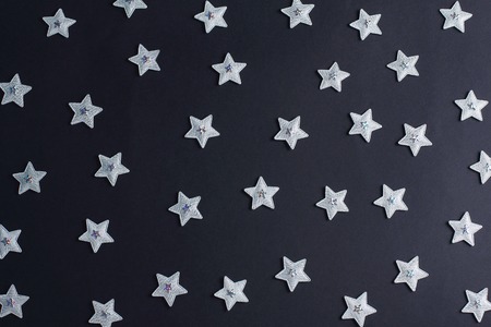 pattern from silvery stars on a black background. creative layoutの写真素材