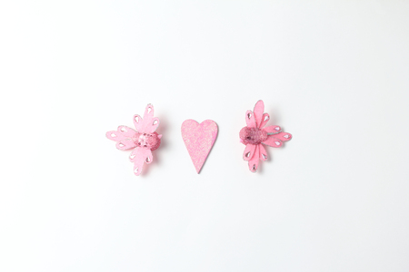 Composition on a white background in the center of the frame. pink figures in the form of hearts and birds. concept for St. Valentine's Dayの写真素材