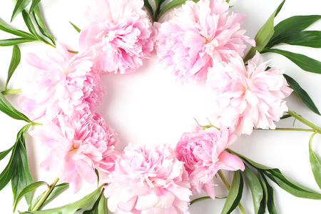 round frame of flowers on a white background. light pink fresh peony flowers. flat lay, top viewの写真素材