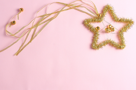 Christmas decoration in the form of a star on a pink background. Holiday concept, flat lay composition, top wievの写真素材